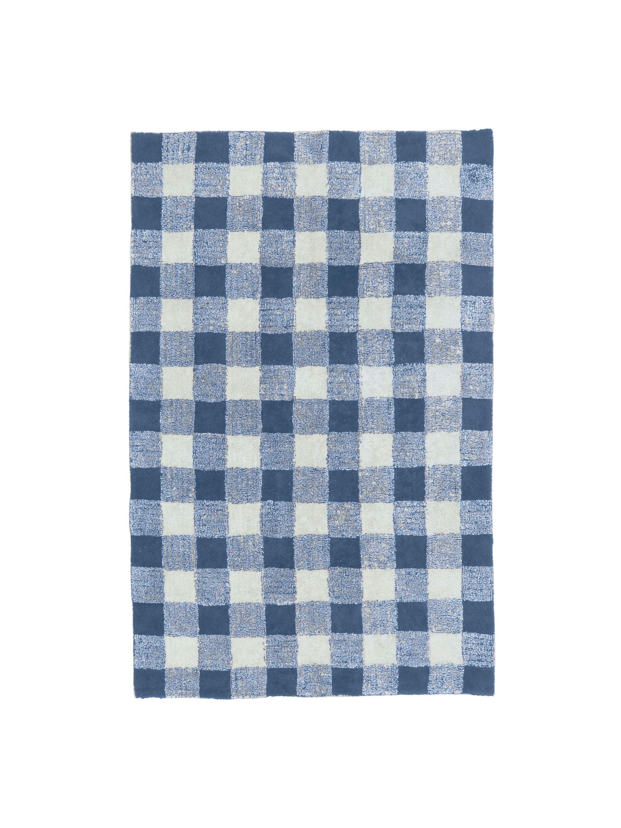 Blue and white checkered rug on a white background